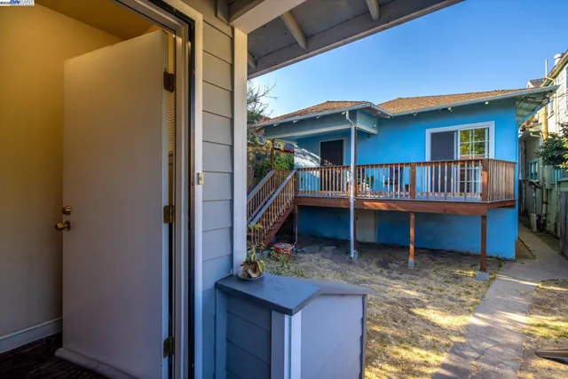 a view of house with deck and balcony