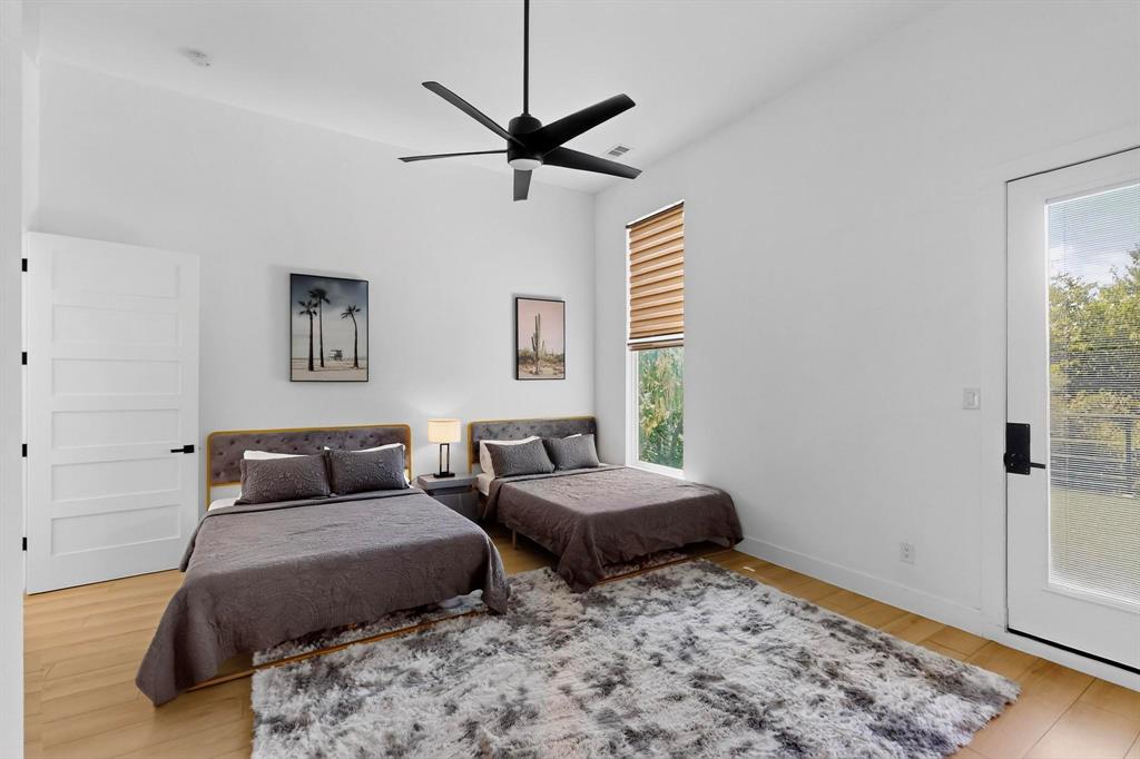 3946 North Cresthaven Road Dallas, TX 75209 - Photo 29 of 38 Spacious room featuring wood-finish flooring, high ceilings, a modern ceiling fan, and ample natural light from a large window with blinds and a glass-paneled door