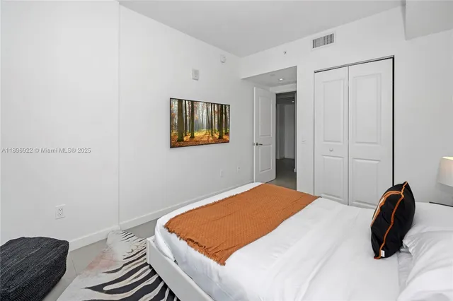 a bedroom with a bed and a couch