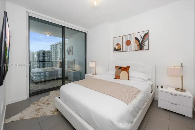 a spacious bedroom with a bed and a large mirror