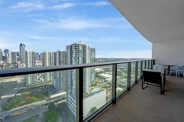 a view of a balcony with two chairs