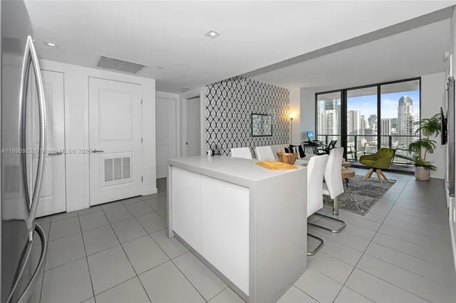 a view of a kitchen with furniture and large window