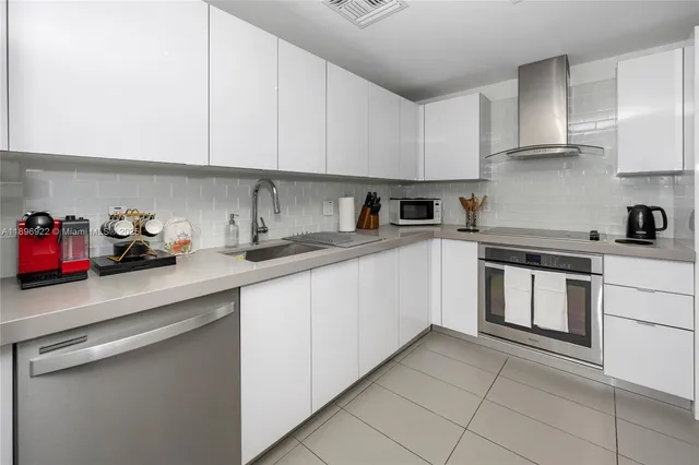 a kitchen with stainless steel appliances granite countertop a sink and cabinets