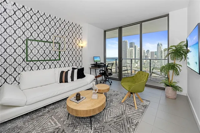 a living room with furniture and a potted plant
