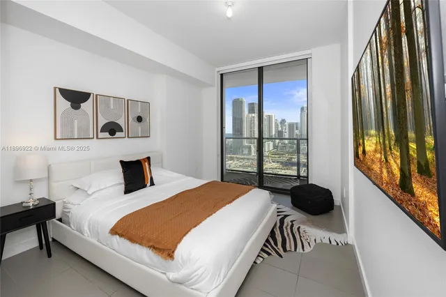 a bedroom with a bed and a large window