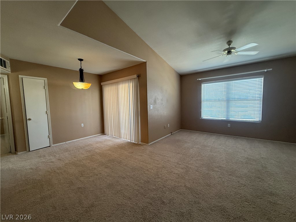 7255 West Sunset Road, Unit 2052 Las Vegas, NV 89113 - Photo 5 of 16 A versatile living area features plush carpeting and a soaring vaulted ceiling with a refreshing ceiling fan.