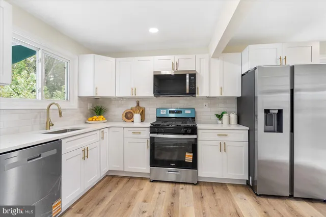 a kitchen with a refrigerator stove and sink