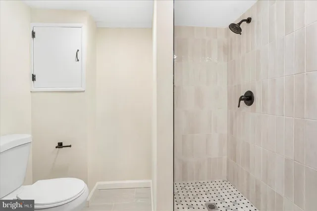 a white toilet sitting next to a bathroom sink