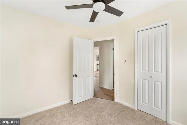 an empty room with ceiling fan