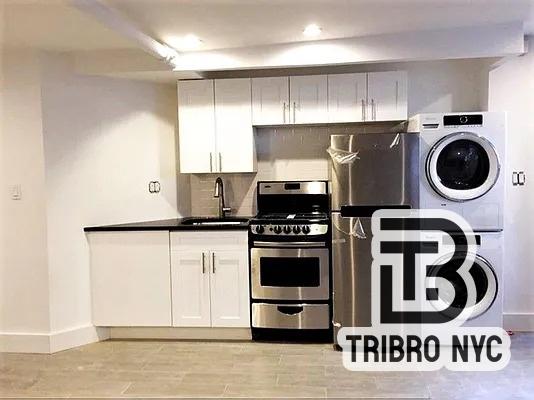 230 East 7th Street, Unit 1A Manhattan, NY 10009 - Photo 1 of 4 a kitchen with a refrigerator and a stove top oven