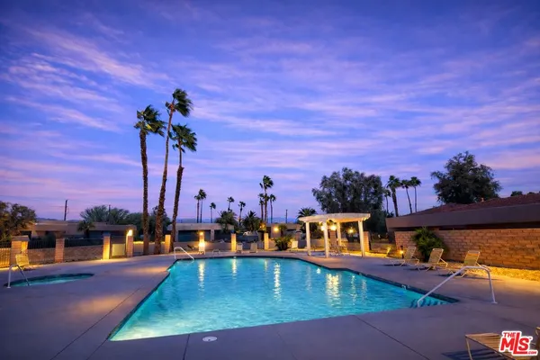 a view of a swimming pool with a table and chairs
