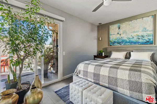 a bedroom with a bed and a large window