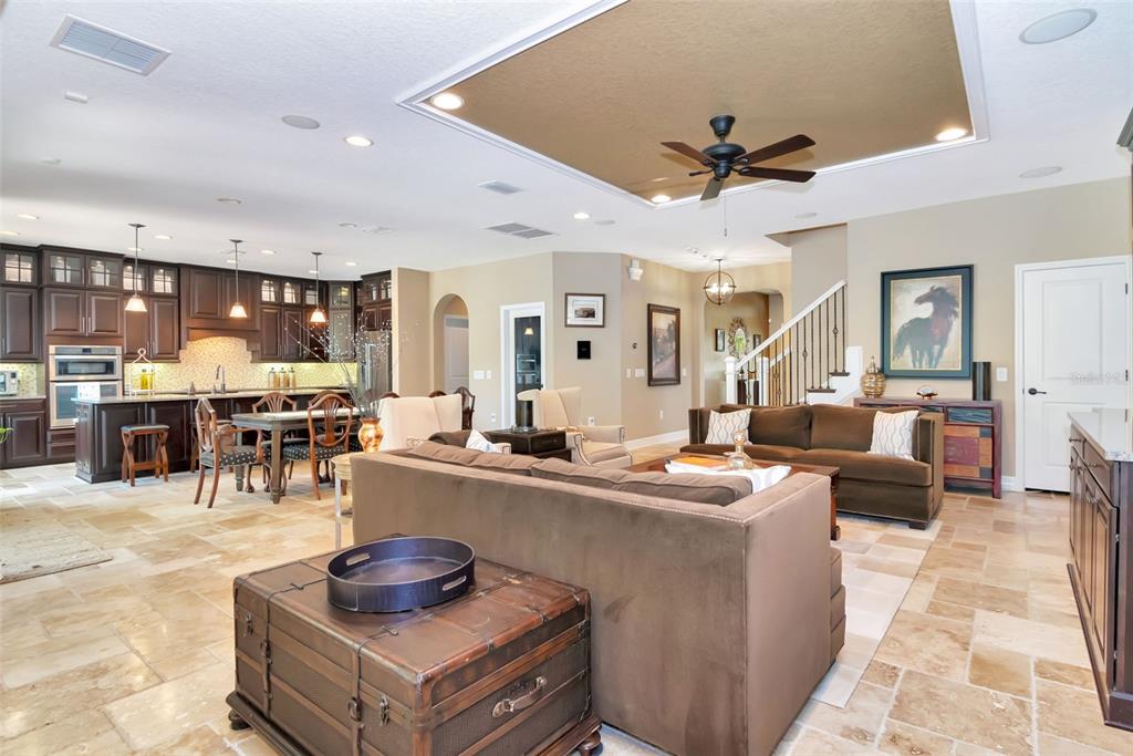 4527 Scarlet Loop Wesley Chapel, FL 33544 - Photo 18 of 57 a living room with stainless steel appliances kitchen island granite countertop furniture a rug and a view of kitchen