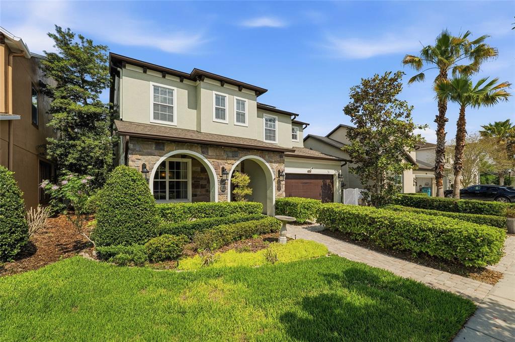 4527 Scarlet Loop Wesley Chapel, FL 33544 - Photo 2 of 57 a front view of a house with a garden