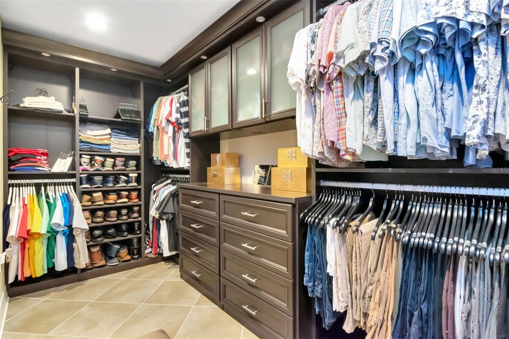 4527 Scarlet Loop Wesley Chapel, FL 33544 - Photo 35 of 57 a view of walk in closet with clothes and shoes