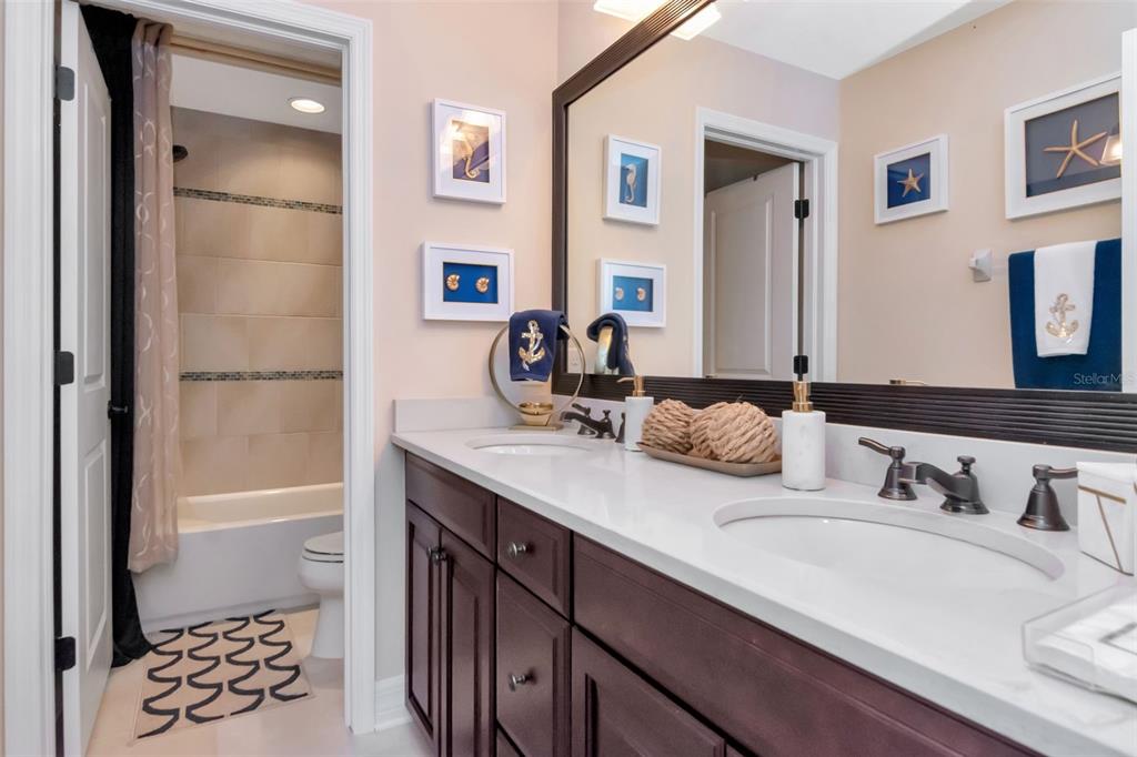 4527 Scarlet Loop Wesley Chapel, FL 33544 - Photo 38 of 57 a bathroom with a double vanity sink mirror and double