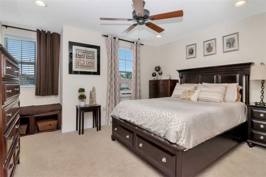 4527 Scarlet Loop Wesley Chapel, FL 33544 - Photo 39 of 57 a bed sitting in a bedroom chandelier and dresser