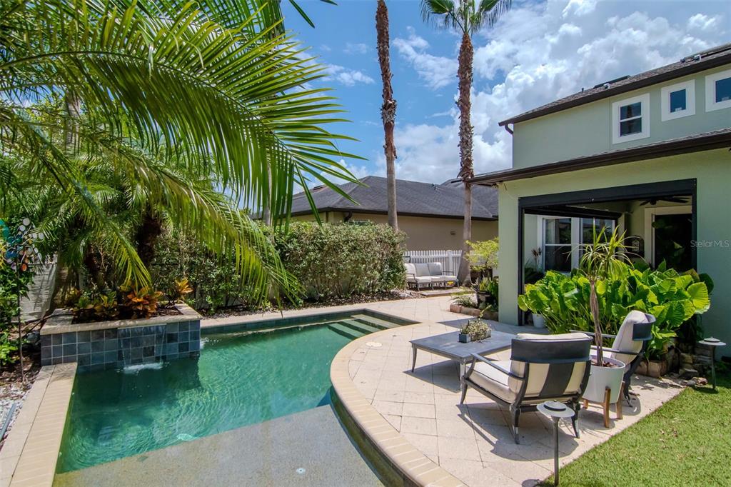 4527 Scarlet Loop Wesley Chapel, FL 33544 - Photo 42 of 57 a view of a house with backyard sitting area and garden