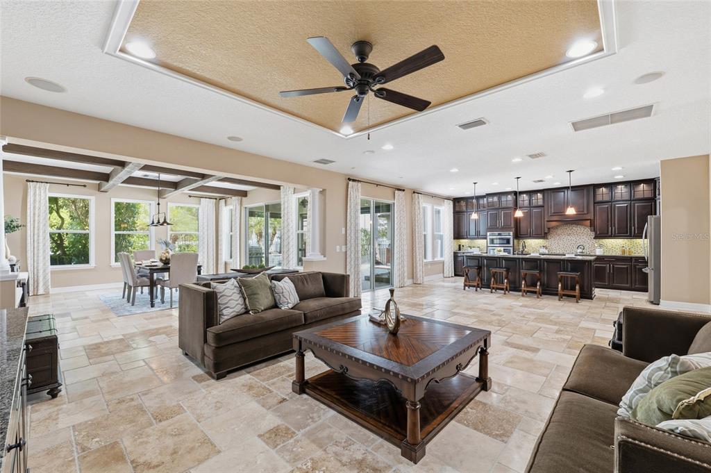 4527 Scarlet Loop Wesley Chapel, FL 33544 - Photo 8 of 57 a living room with furniture ceiling fan and a large window
