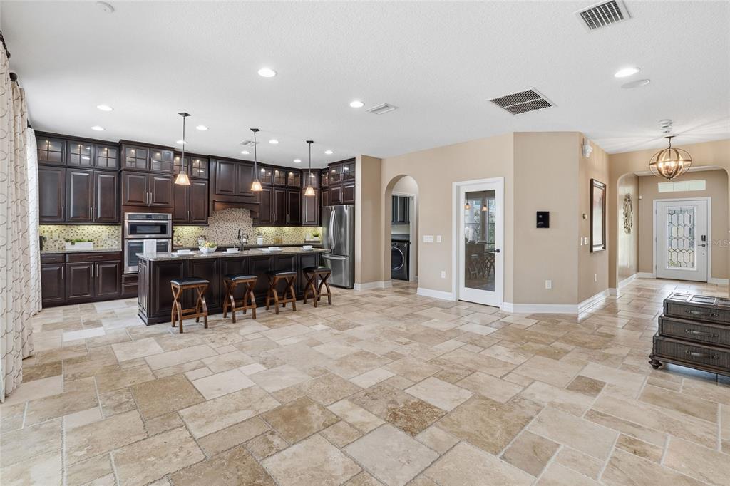 4527 Scarlet Loop Wesley Chapel, FL 33544 - Photo 10 of 57 a view of kitchen with stainless steel appliances kitchen island granite countertop a refrigerator and a sink