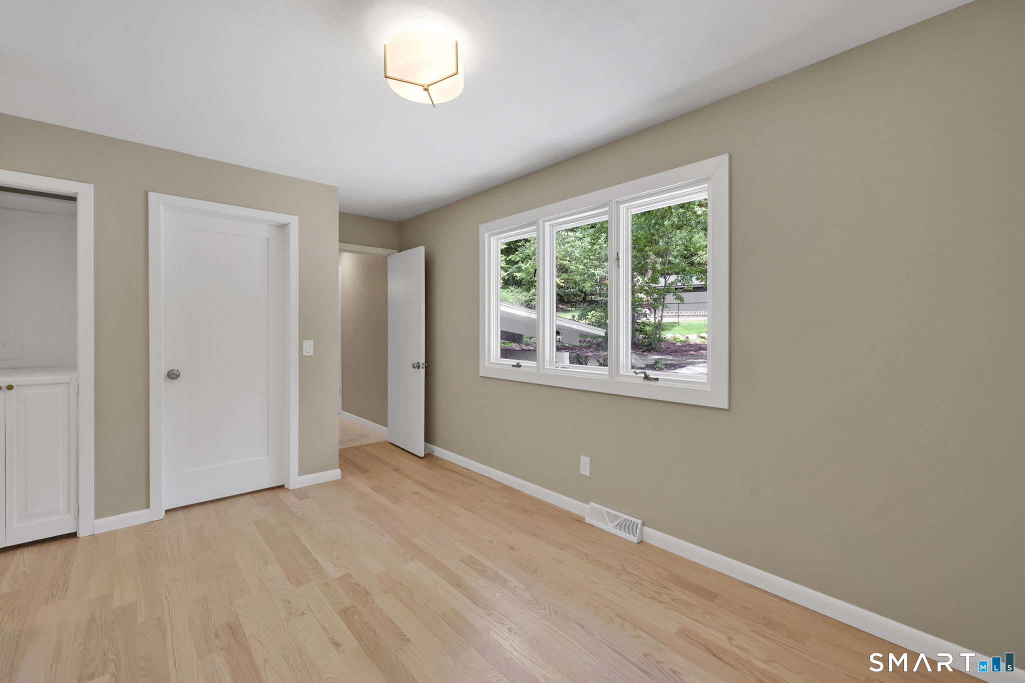 49 Millstone Road Glastonbury, CT 06033 - Photo 16 of 39 an empty room with wooden floor and windows