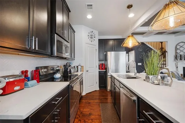a kitchen with a sink stainless steel appliances and cabinets