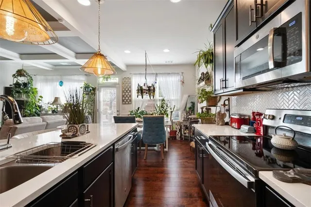 a kitchen with lots of counter top space and wooden floor