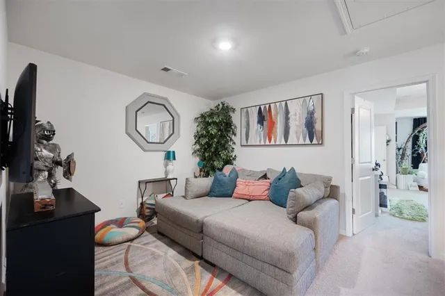 a living room with furniture and a wall painting