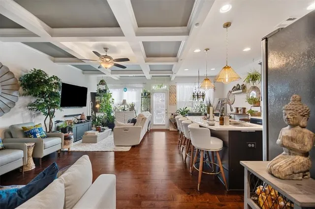a living room with furniture kitchen view and a large mirror