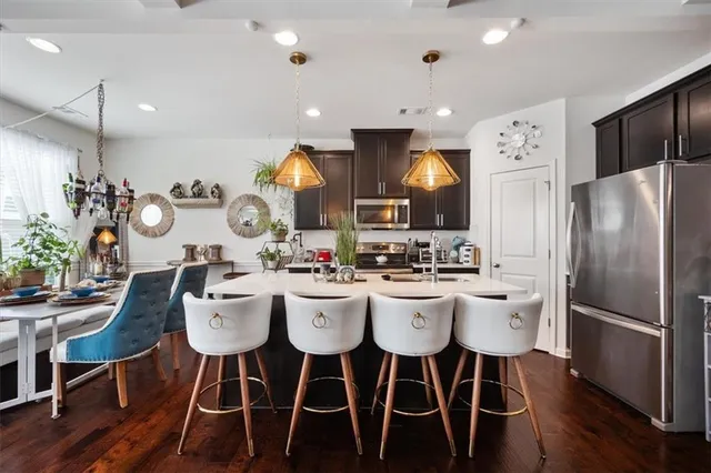 a large kitchen with a table and chairs