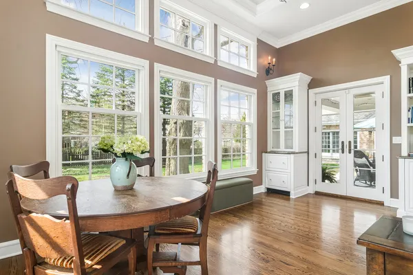 a living room with furniture and floor to ceiling windows