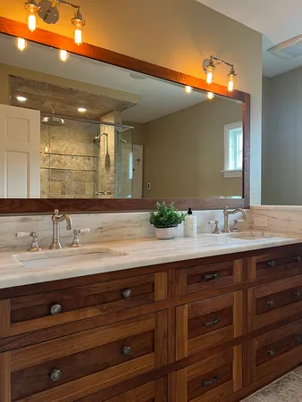 a bathroom with a granite countertop sink mirror and double