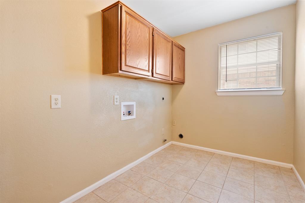 7517 Point Reyes Drive Fort Worth, TX 76137 - Photo 25 of 30 Laundry room featuring wood-finish cabinetry, tile flooring, window with blinds, and appliance hookups
