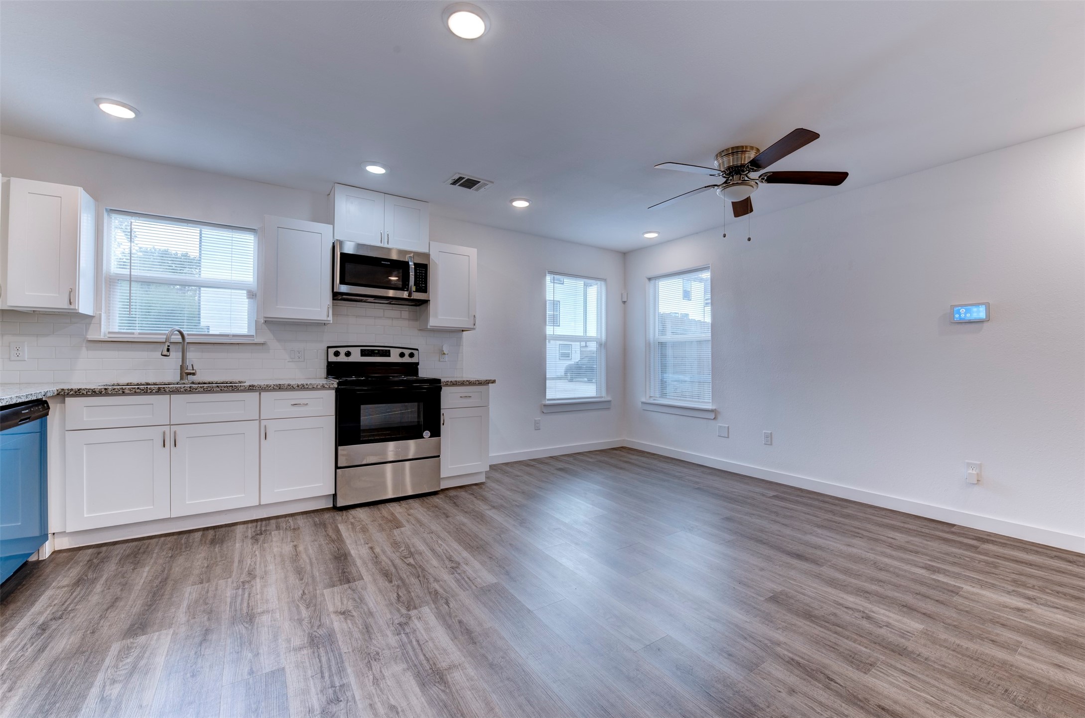 6309 Sandra Street, Unit B/2 Houston, TX 77028 - Photo 11 of 23 a kitchen with granite countertop a stove a sink and a refrigerator