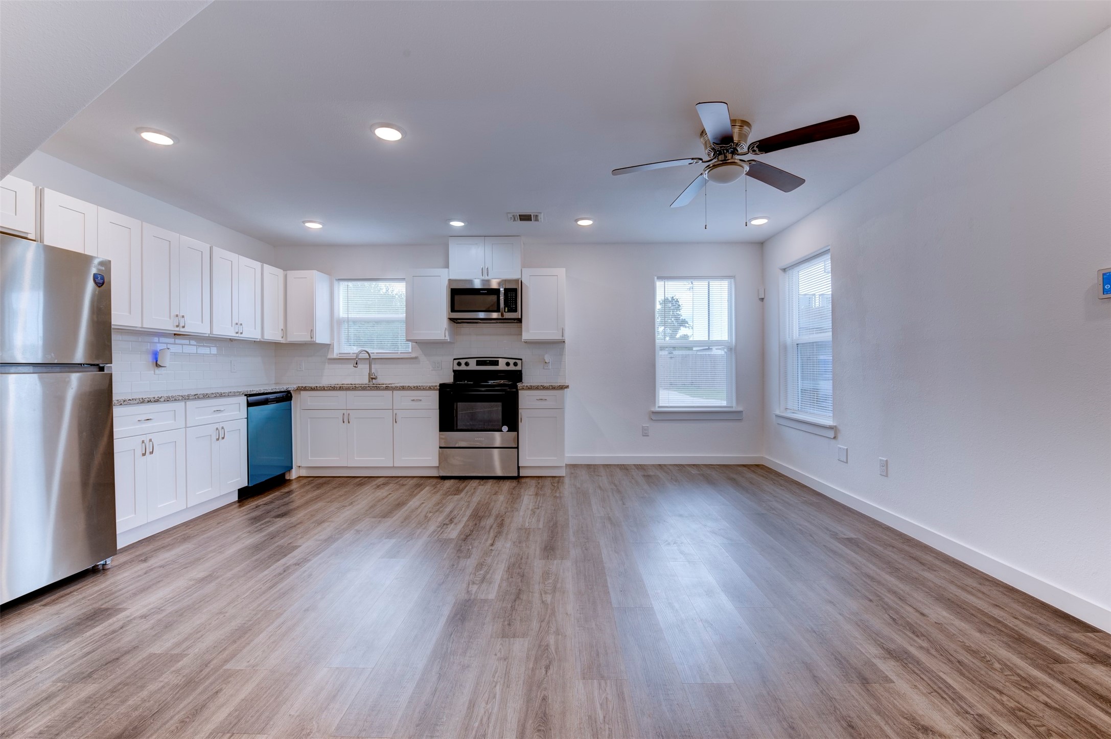 6309 Sandra Street, Unit B/2 Houston, TX 77028 - Photo 12 of 23 a view of kitchen with refrigerator microwave and stove top oven