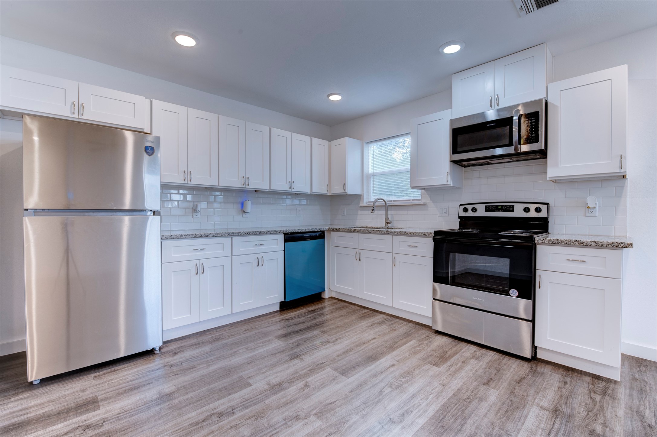 6309 Sandra Street, Unit B/2 Houston, TX 77028 - Photo 13 of 23 a kitchen with a white cabinets and white appliances