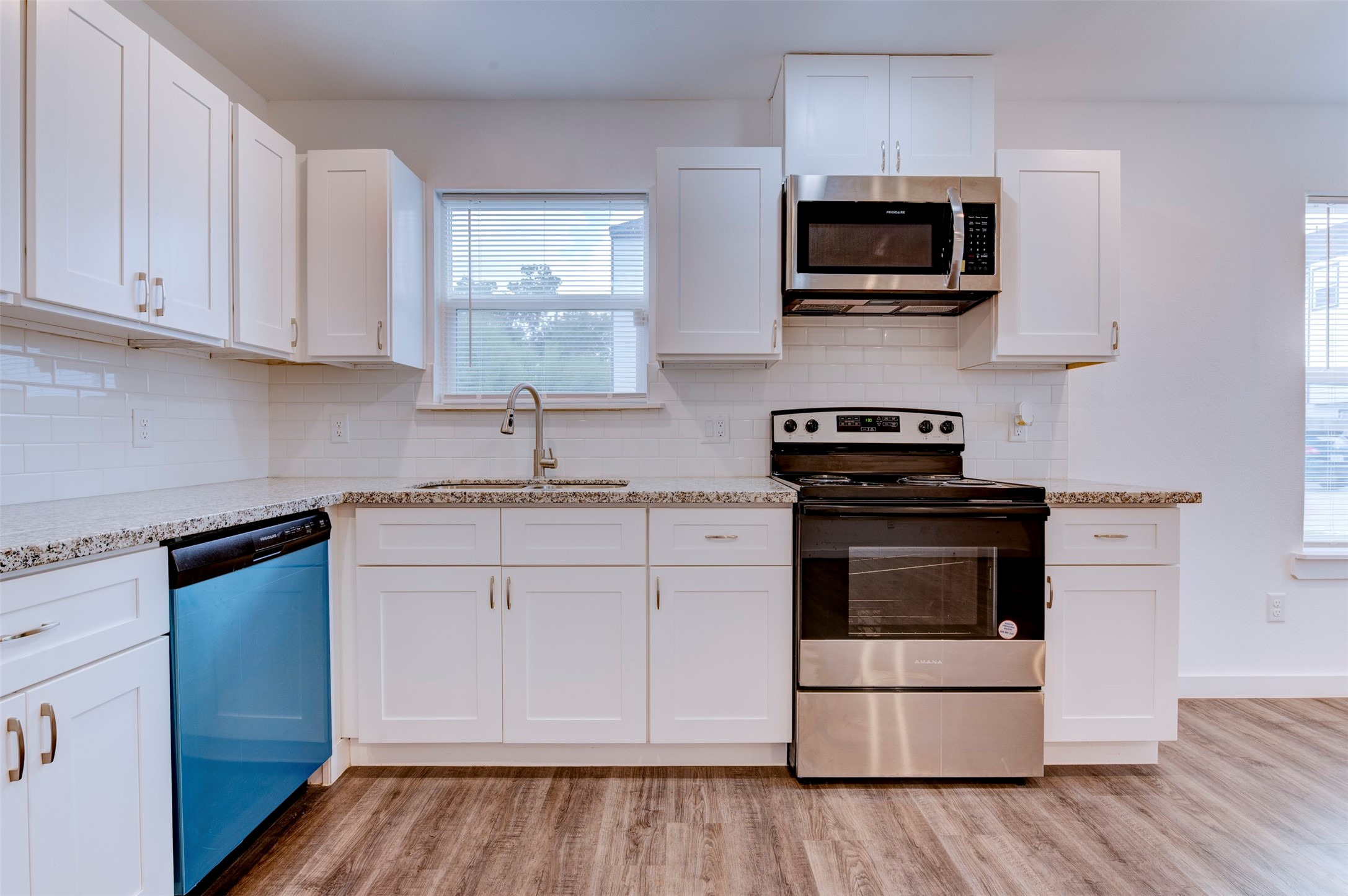 6309 Sandra Street, Unit B/2 Houston, TX 77028 - Photo 14 of 23 a kitchen with white cabinets and stainless steel appliances