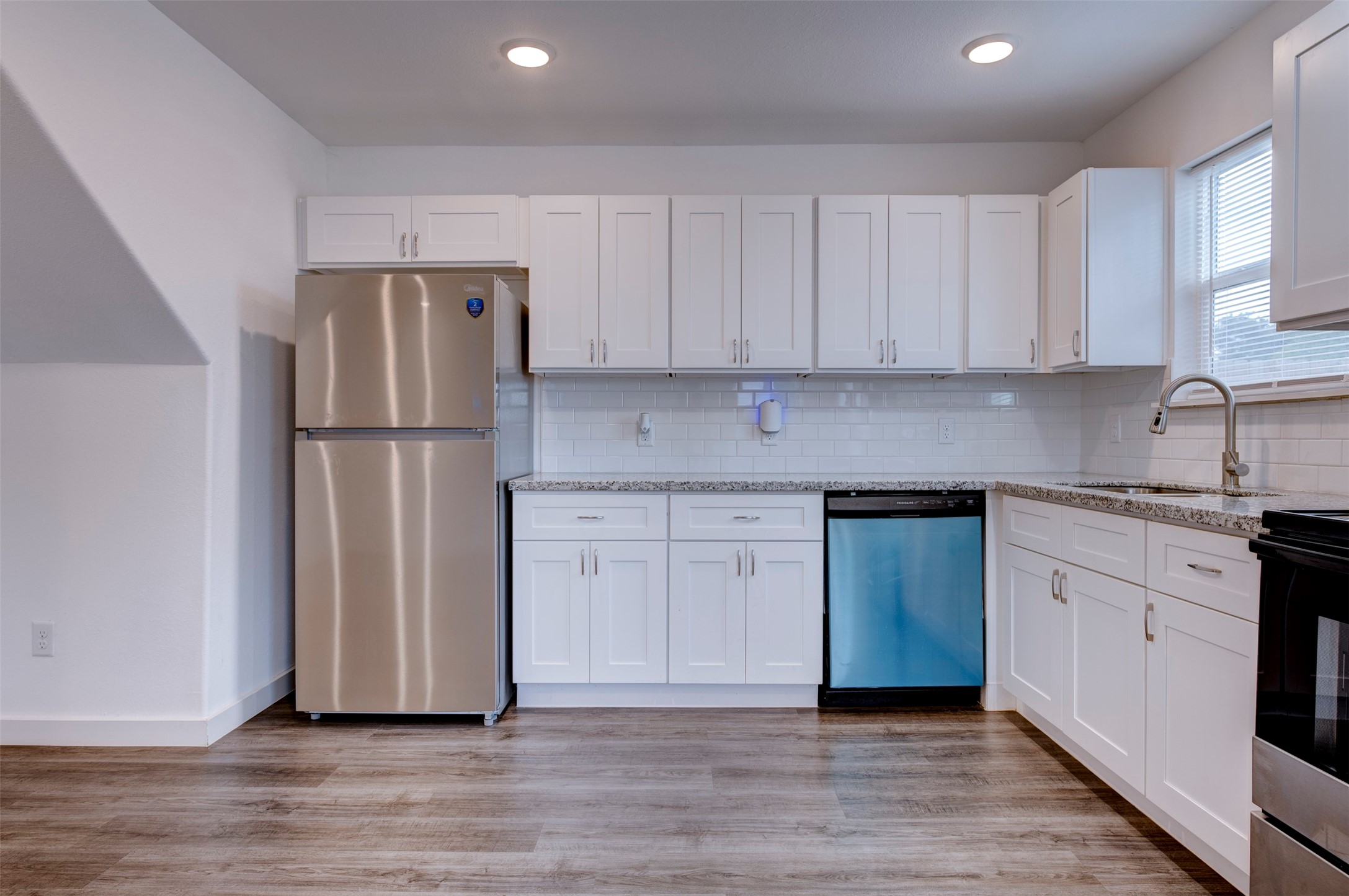 6309 Sandra Street, Unit B/2 Houston, TX 77028 - Photo 15 of 23 a kitchen with a refrigerator sink and cabinets