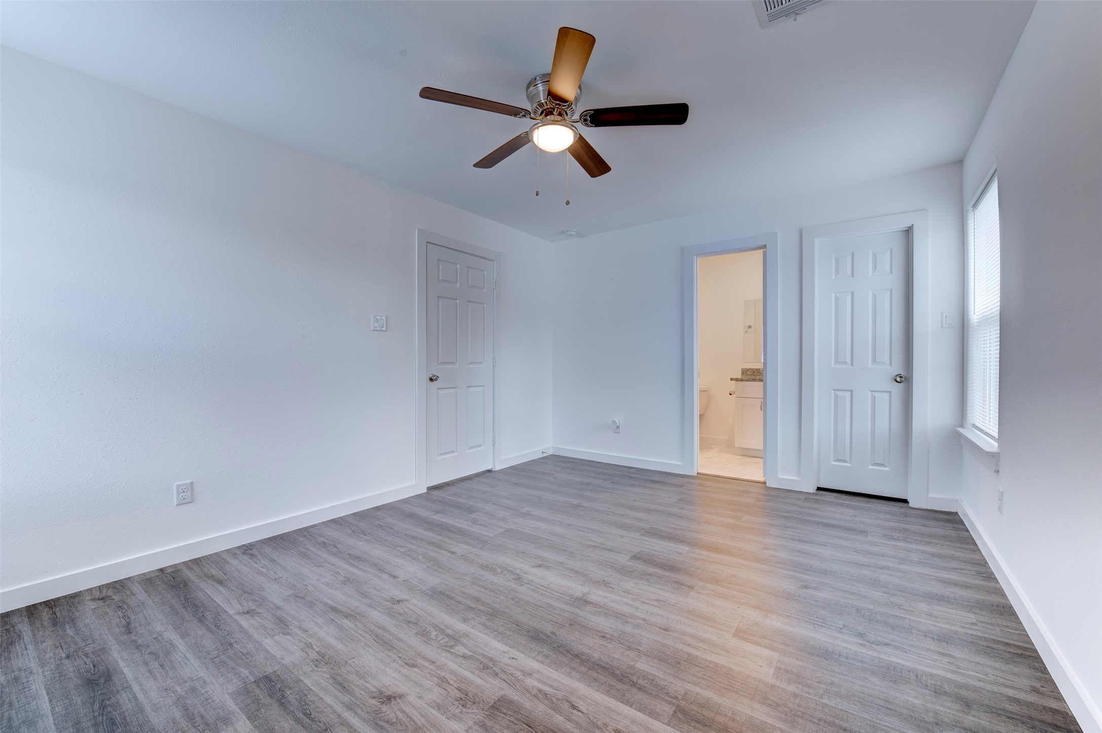 6309 Sandra Street, Unit B/2 Houston, TX 77028 - Photo 21 of 23 an empty room with wooden floor ceiling fan and windows