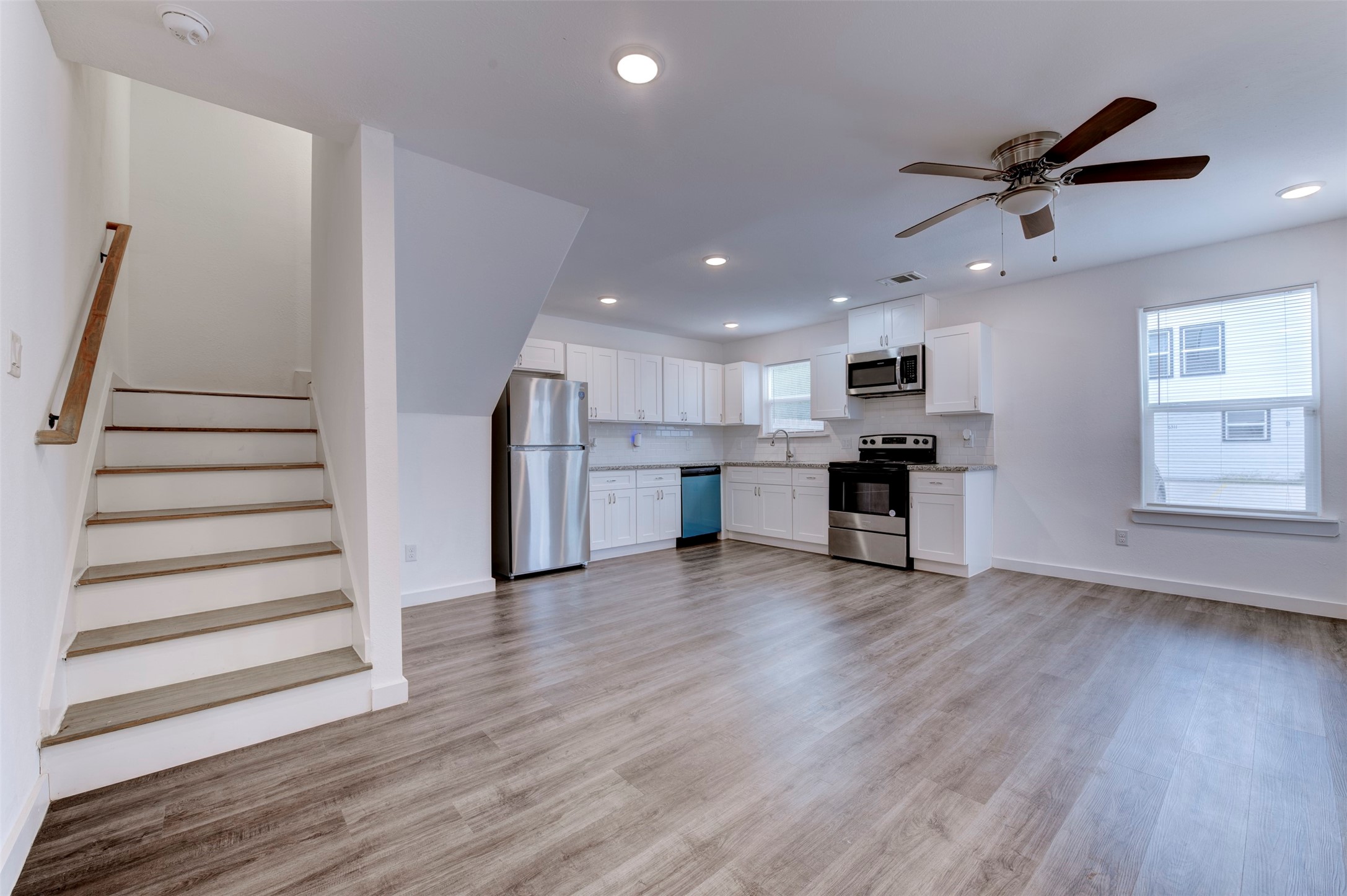 6309 Sandra Street, Unit B/2 Houston, TX 77028 - Photo 5 of 23 a view of kitchen with refrigerator microwave and wooden floor