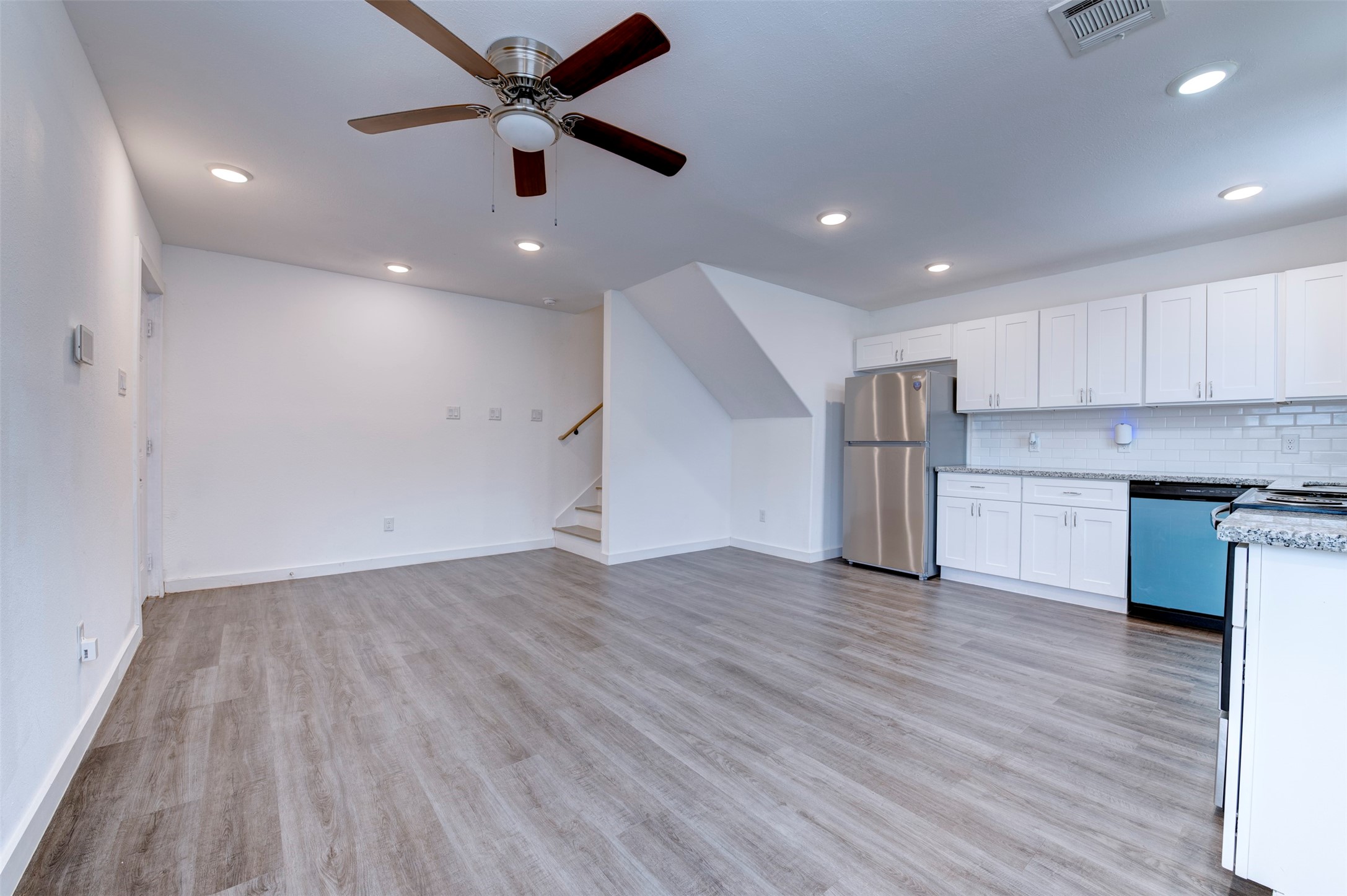 6309 Sandra Street, Unit B/2 Houston, TX 77028 - Photo 7 of 23 an empty room with wooden floor and a ceiling fan