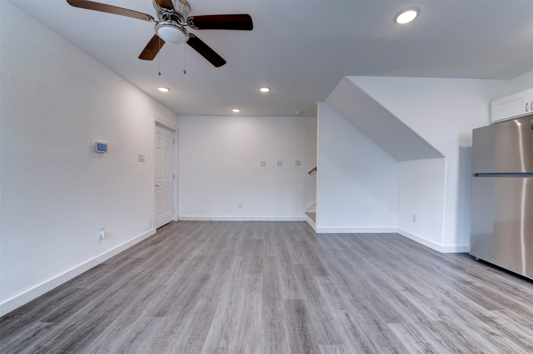 6309 Sandra Street, Unit B/2 Houston, TX 77028 - Photo 8 of 23 an empty room with wooden floor ceiling fan and windows