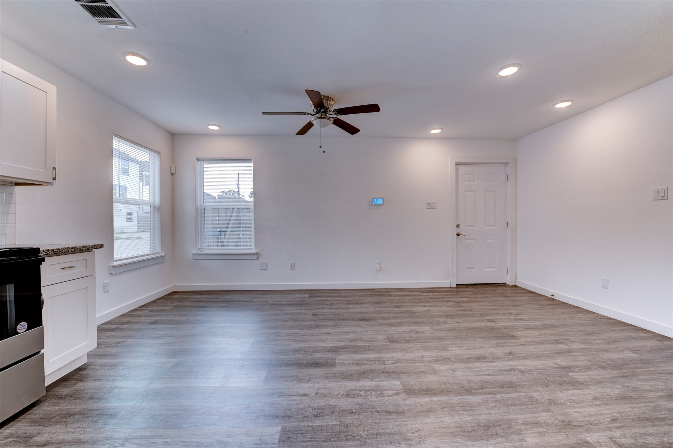 6309 Sandra Street, Unit B/2 Houston, TX 77028 - Photo 10 of 23 an empty room with wooden floor ceiling fan and windows