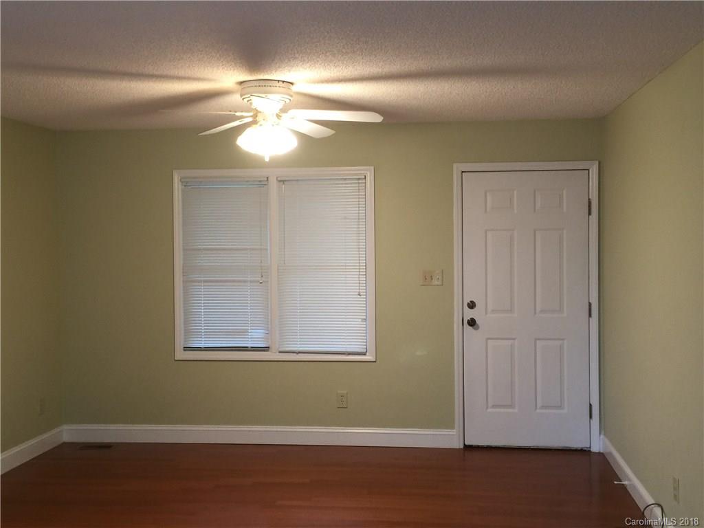 8667 Unity Church Road Denver, NC 28037 - Photo 2 of 23 an empty room with windows and fan