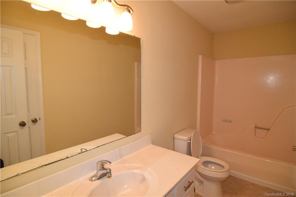 8667 Unity Church Road Denver, NC 28037 - Photo 12 of 23 a bathroom with a sink and a toilet