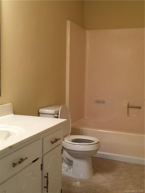 8667 Unity Church Road Denver, NC 28037 - Photo 13 of 23 a bathroom with a granite countertop toilet and a sink