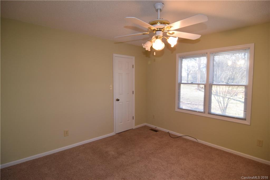 8667 Unity Church Road Denver, NC 28037 - Photo 14 of 23 an empty room with windows and fan