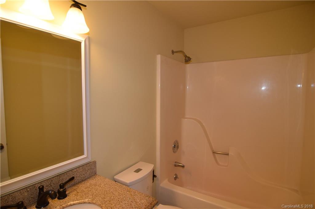 8667 Unity Church Road Denver, NC 28037 - Photo 15 of 23 a bathroom with a granite countertop shower and a toilet