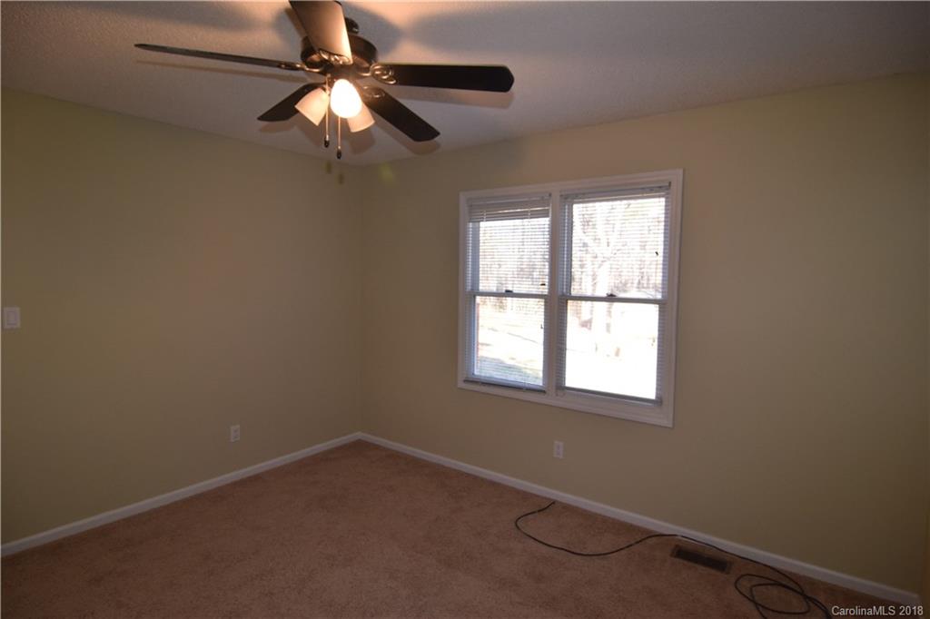 8667 Unity Church Road Denver, NC 28037 - Photo 16 of 23 an empty room with a window