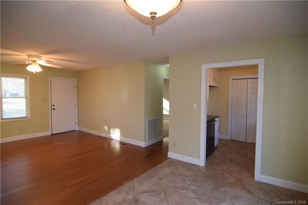 8667 Unity Church Road Denver, NC 28037 - Photo 5 of 23 a view of a big room with windows and cabinet
